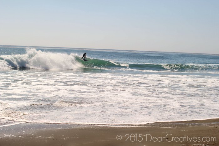 Surfer surfing at a CA beach