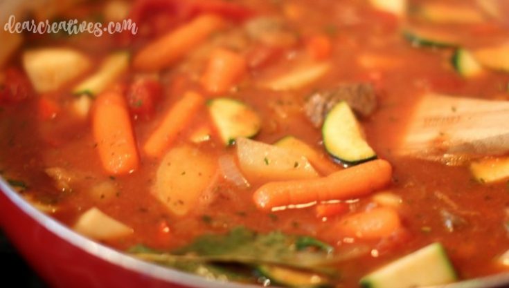 Italian Beef Stew cooking in the stew pot. This recipe is easy to make, cooks for several hours to get that tender beef and perfect for fall or winter dinners. See the recipe and variations at DearCreatives.com