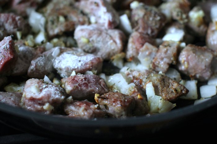 dredged beef halfway done cooking in skillet for beef stew 