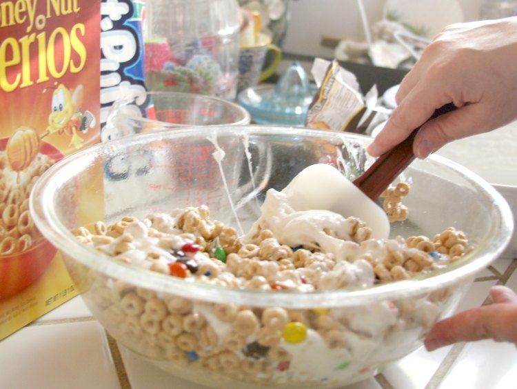 making cereal treats in a big mixing bowl