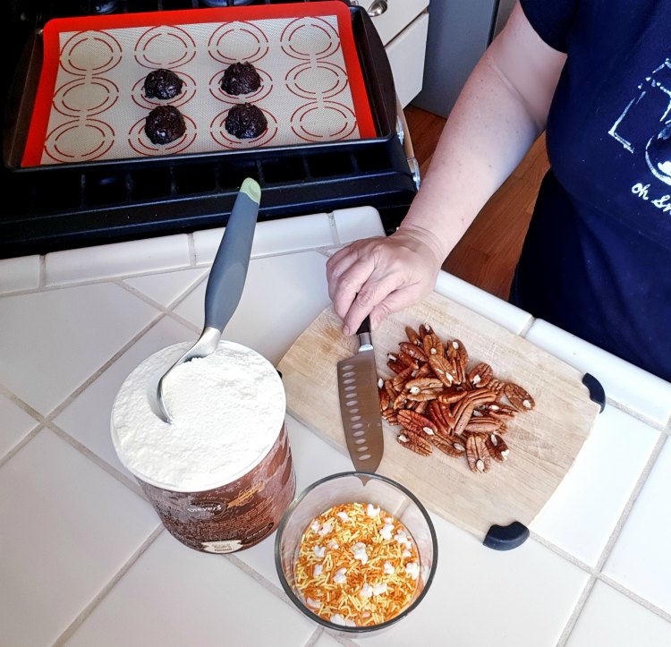 Chopping pecans for ice cream stuffed cookies treat recipe