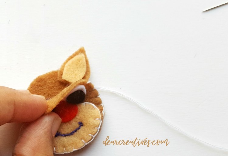 for step (7) place ears in between front of reindeer head and place on inside back of the deer head. DearCreatives.com #reindeerornament