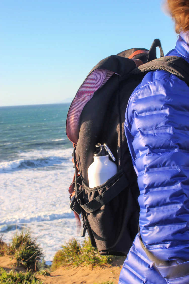 Hiking on the Central Coast, California - Carrying an american shield backpack with ocean in the background. © 2019 Theresa Huse DearCreatives.com