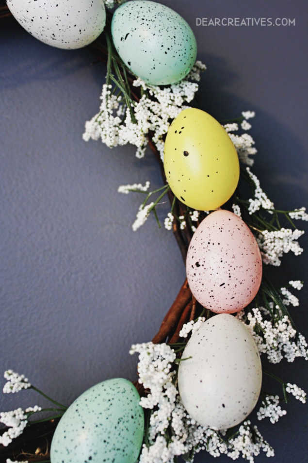 Easter Egg Wreath - Close up of faux eggs on a grapevine wreath with white flowers. DIY wreath at DearCreatives.com