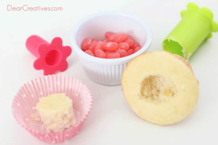 Coring out the center of the cupcake to be able to insert the jelly beans - DIY jelly bean cupcakes at DearCreatives.com