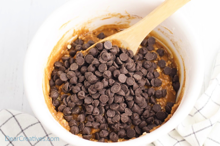 Adding chocolate chips to the batter for baking cookies. DearCreatives.com