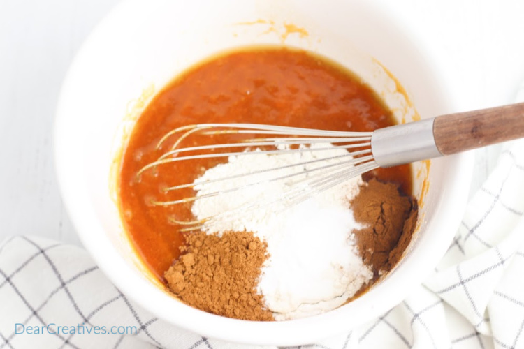 Adding flour, baking soda, and spices for oatmeal pumpkin cookies. Cookies recipe at DearCreatives.com