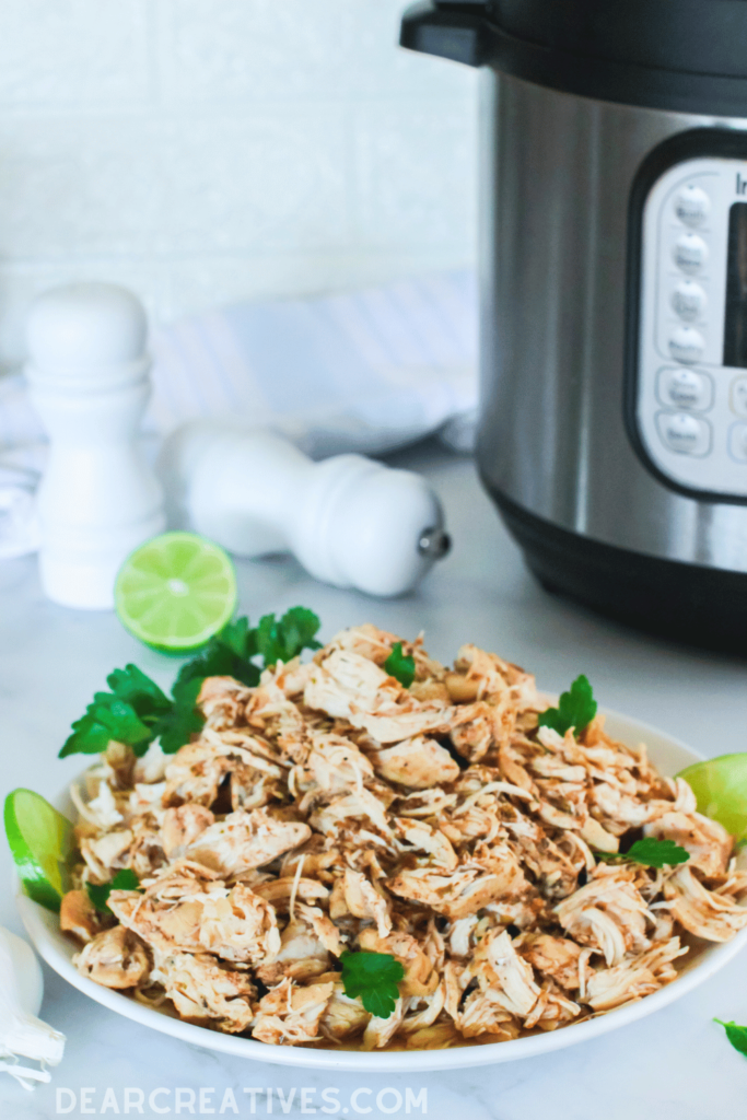 Shredded Chicken cooked in the Instant Pot - Print the recipe at DearCreatives.com ( cooked chicken breast shredded for tacos, burritos, rice bowls with chicken, and...) Print the recipe at DearCreatives.com