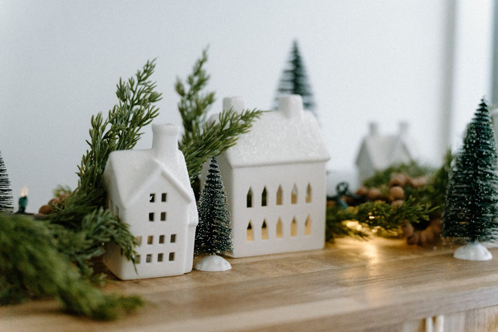 Christmas  village surrounded by greenery and holiday lights