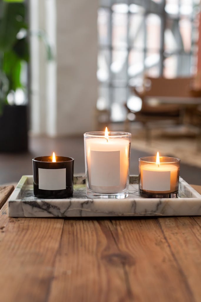 A close-up of burning candles on a wooden table with a soft, warm ambiance.