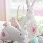 Charming Easter setup with ceramic bunnies and pastel eggs, perfect for celebrating spring.