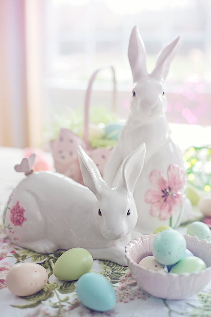 Charming Easter setup with ceramic bunnies and pastel eggs, perfect for celebrating spring.