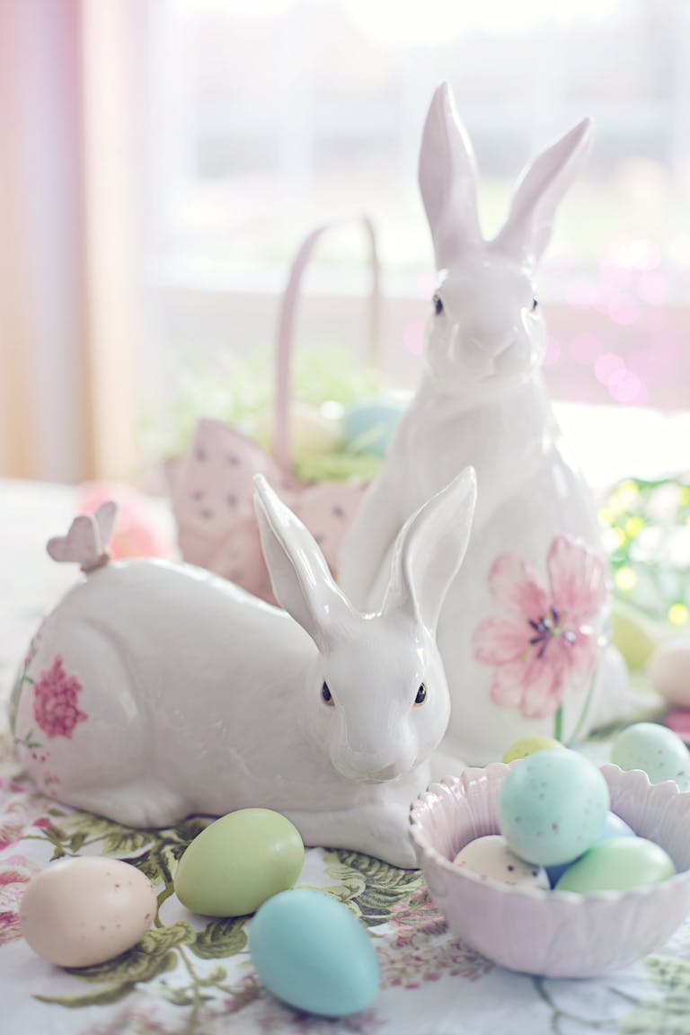 Charming Easter setup with ceramic bunnies and pastel eggs, perfect for celebrating spring.