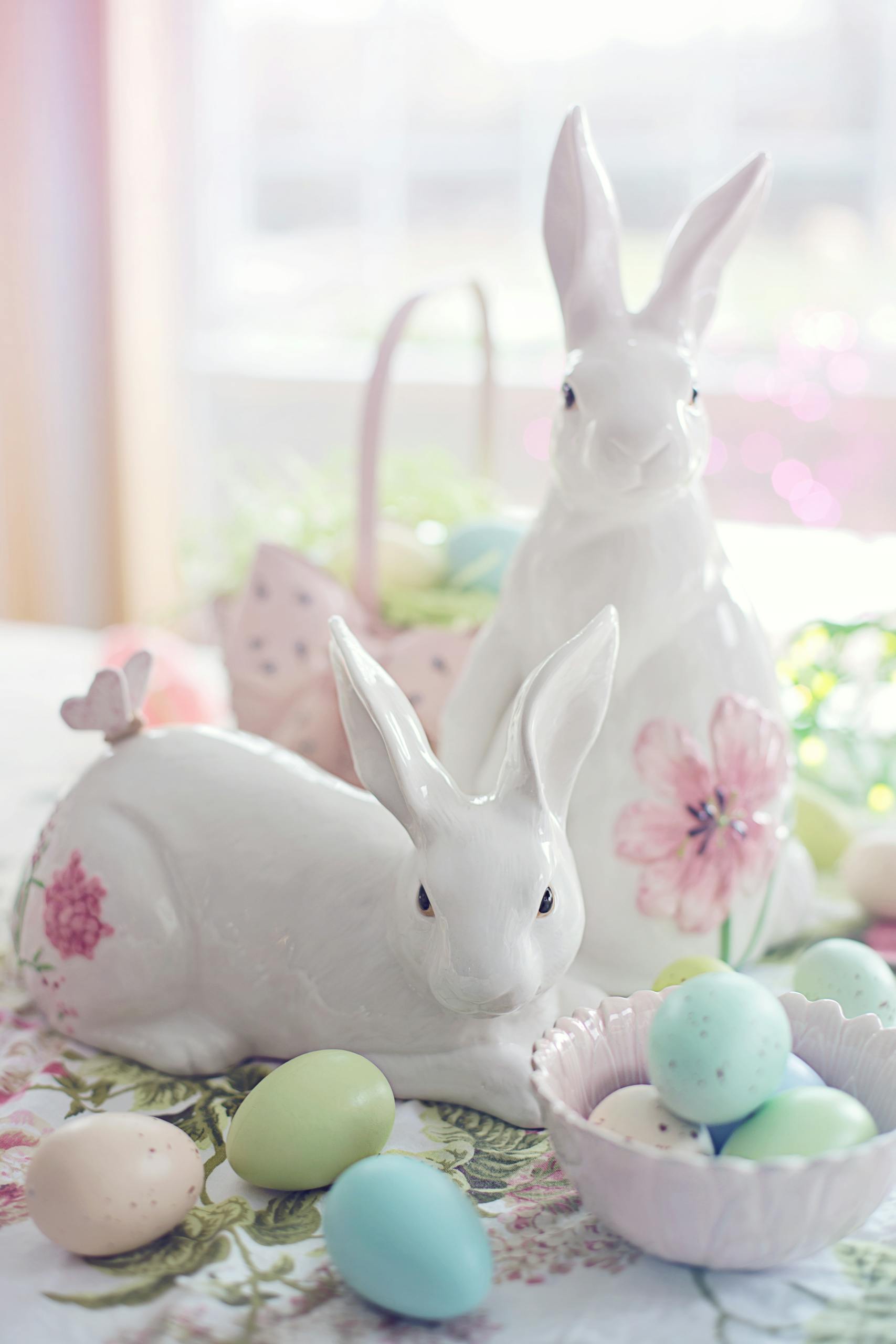 Charming Easter setup with ceramic bunnies and pastel eggs, perfect for celebrating spring.