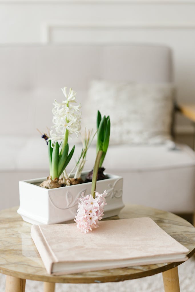 Decorate for spring: Stylish marble table setup with spring flowers-hyacinths and a book. Spring home refresh click over to see all the decor accents to create a beautiful spring home. 