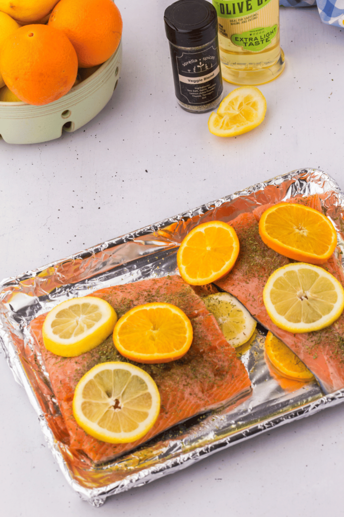 Salmon Dinner Recipe - Prepped and ready to go into the oven to cook. Sheet Pan Salmon With Citrus and herbs. Quick and Easy Recipe DearCreatives.com