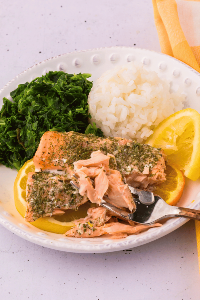 Salmon Dinner Recipe Salmon Baked in the oven on a sheet pan with oranges and lemons, and herbs. Side dishes sticky rice and kale but, pick favorite sides. Salmon Recipe at DearCreatives.com